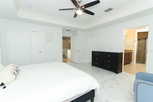 bedroom with marble finish floor, a tray ceiling, visible vents, and crown molding