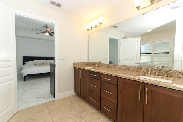 ensuite bathroom featuring marble finish floor, visible vents, a sink, and double vanity