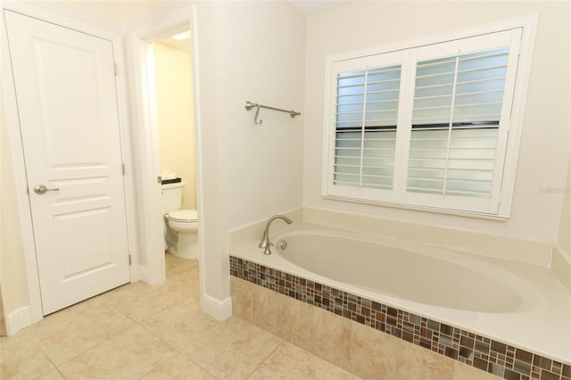 bathroom featuring a bath, tile patterned flooring, and toilet