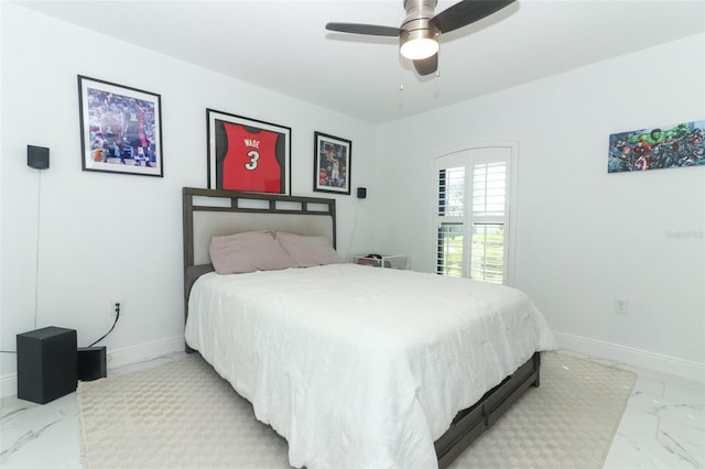 bedroom featuring marble finish floor, ceiling fan, and baseboards