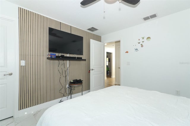 bedroom with marble finish floor, baseboards, visible vents, and ceiling fan