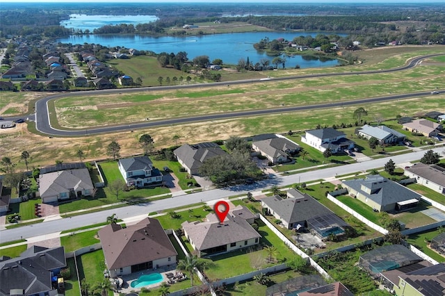 bird's eye view featuring a water view and a residential view