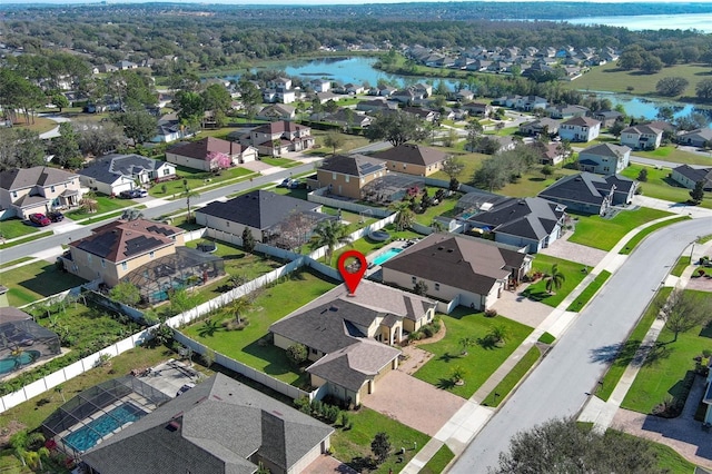 drone / aerial view with a water view and a residential view