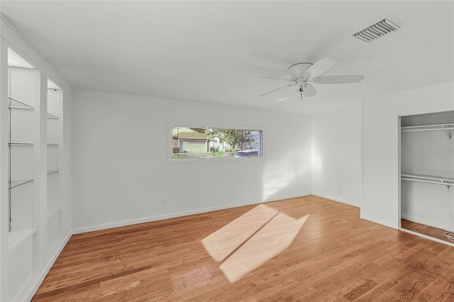 unfurnished bedroom featuring ceiling fan, visible vents, baseboards, a closet, and light wood-type flooring