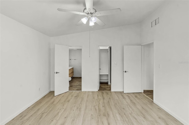 unfurnished bedroom with light wood finished floors, visible vents, connected bathroom, ceiling fan, and baseboards