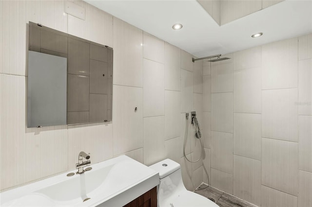 full bathroom with toilet, recessed lighting, tiled shower, and vanity