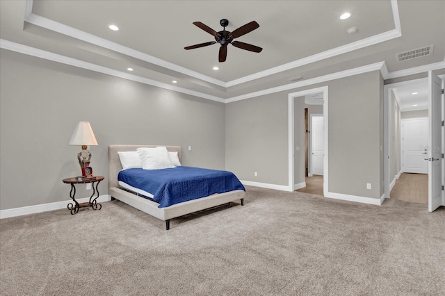 carpeted bedroom with recessed lighting, visible vents, baseboards, ornamental molding, and a tray ceiling