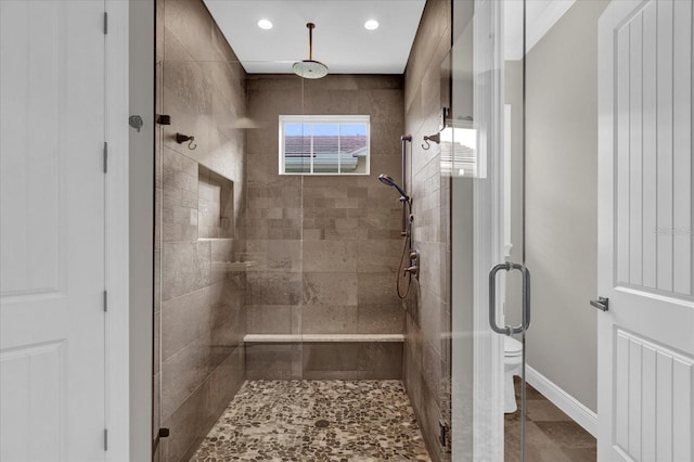 full bathroom featuring recessed lighting, baseboards, a shower stall, and toilet