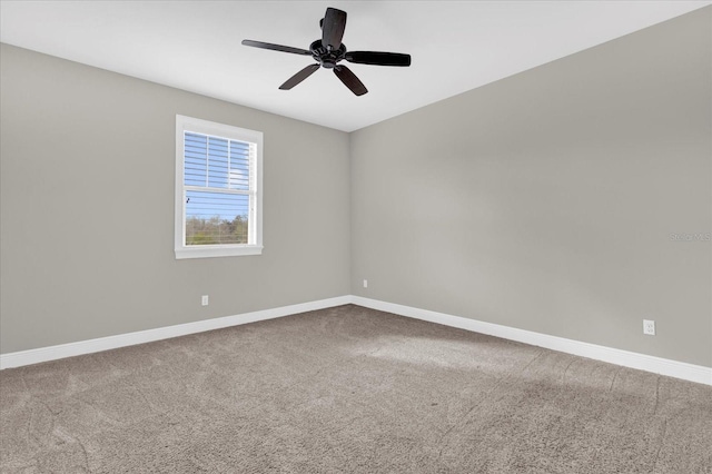 spare room featuring carpet flooring, a ceiling fan, and baseboards