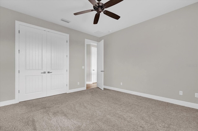 unfurnished bedroom featuring visible vents, a closet, baseboards, and carpet flooring