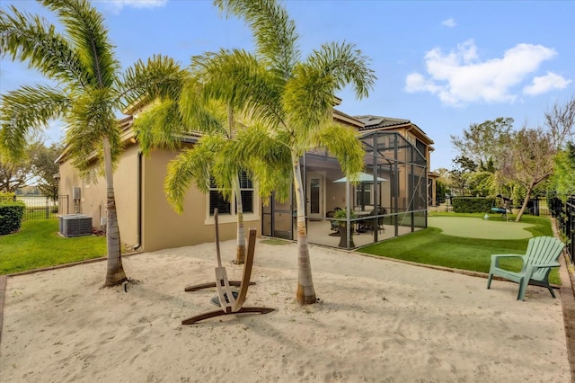 back of property with glass enclosure, a patio area, fence, and stucco siding