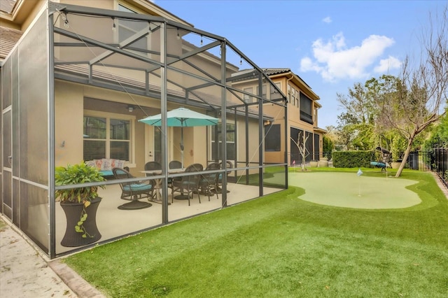 back of house featuring a lanai, a patio, and stucco siding