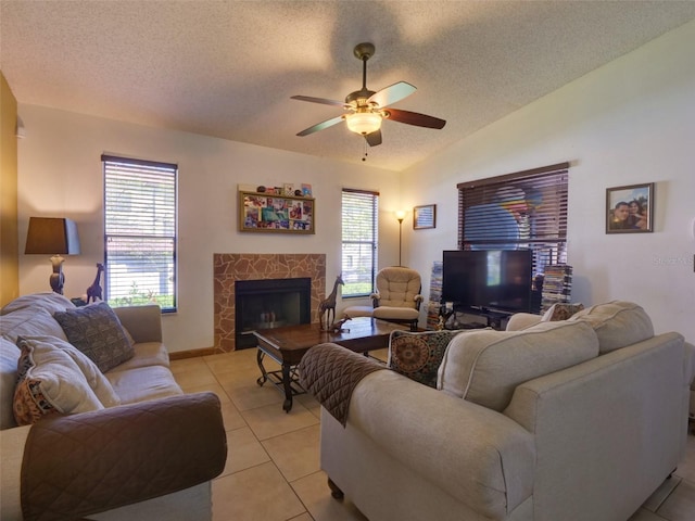 living room featuring vaulted ceiling, light tile patterned floors, a textured ceiling, and a fireplace