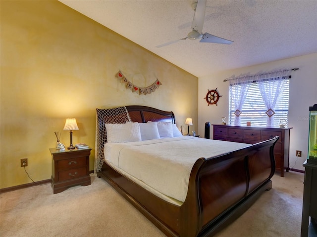 carpeted bedroom featuring lofted ceiling, ceiling fan, a textured ceiling, and baseboards