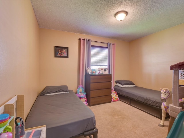 bedroom with carpet floors and a textured ceiling