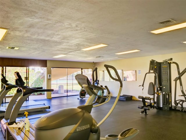 workout area with a textured ceiling and visible vents