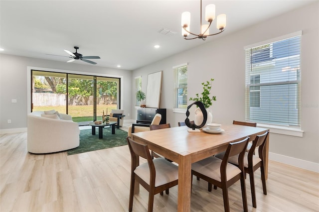 dining space with recessed lighting, visible vents, baseboards, light wood-type flooring, and ceiling fan with notable chandelier