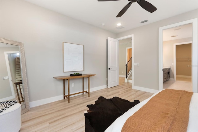 bedroom featuring wood finished floors, visible vents, and baseboards