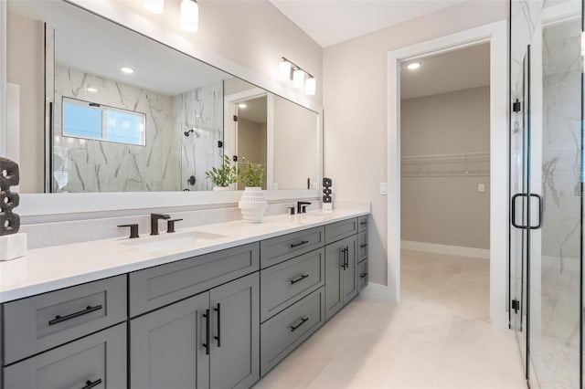 full bath featuring a sink, a marble finish shower, and double vanity