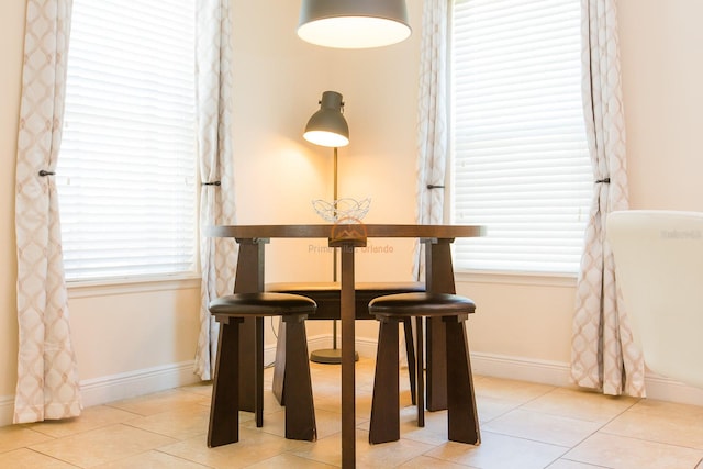 dining room featuring light tile patterned floors and baseboards