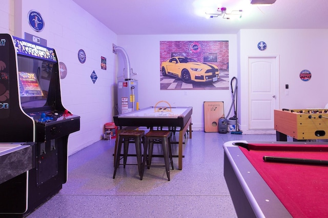 playroom featuring pool table, water heater, and speckled floor