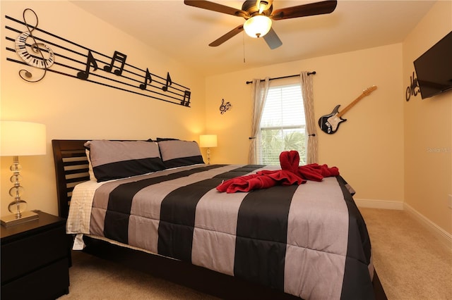 carpeted bedroom featuring ceiling fan and baseboards