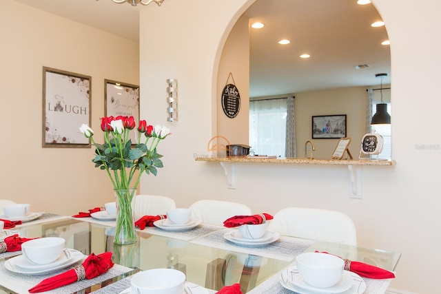 dining space featuring visible vents, arched walkways, and recessed lighting