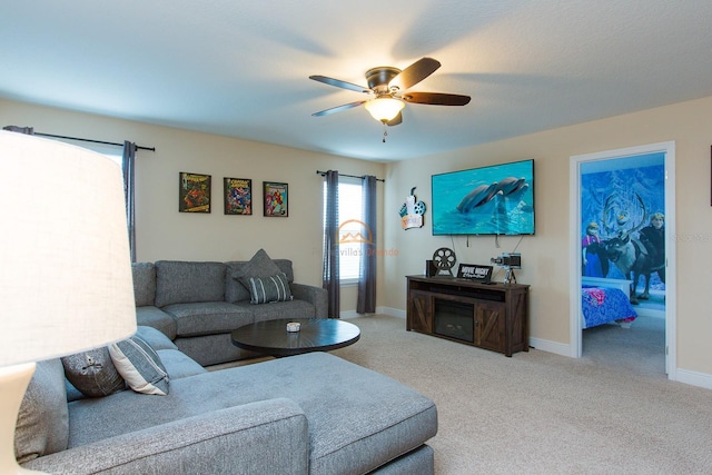 living room featuring a ceiling fan, light colored carpet, and baseboards