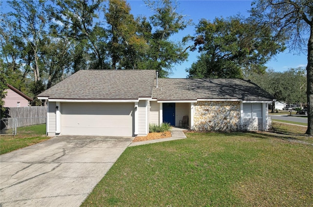 ranch-style home with a garage, fence, driveway, roof with shingles, and a front lawn