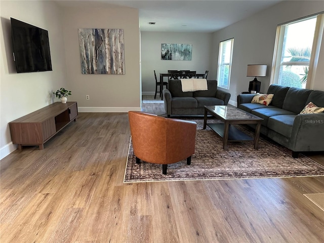 living area featuring wood finished floors and baseboards