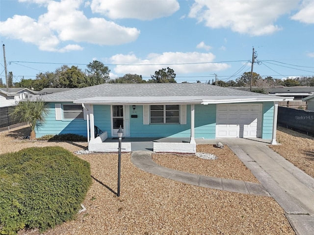 ranch-style house featuring driveway, roof with shingles, an attached garage, and fence