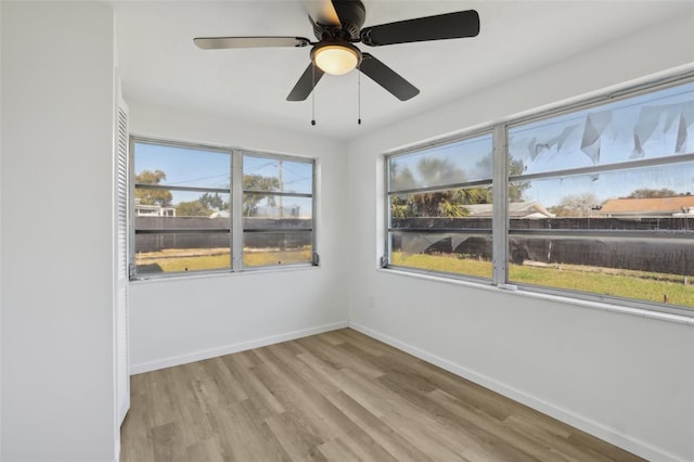 empty room with light wood-type flooring and baseboards