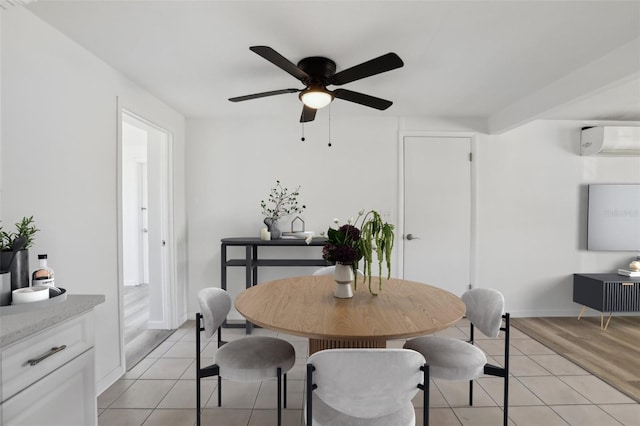 dining area with baseboards, light tile patterned flooring, ceiling fan, and a wall mounted AC