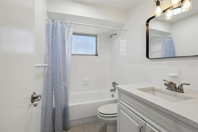 full bath with tile walls, toilet, shower / bath combo with shower curtain, vanity, and tile patterned floors