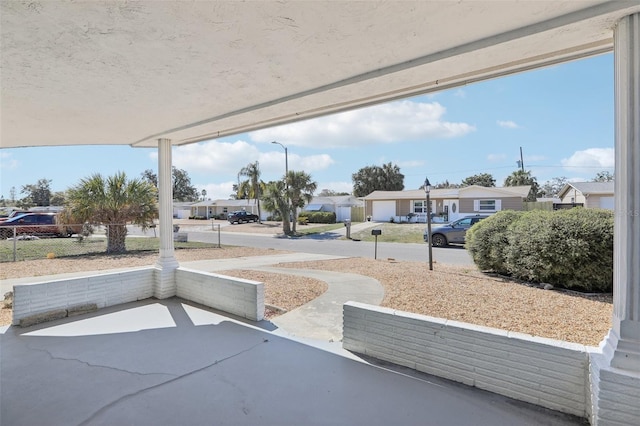 view of patio featuring a residential view and fence