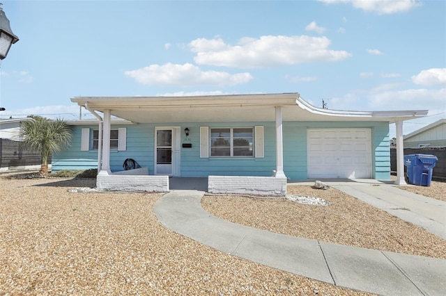 view of front of property featuring driveway, a porch, and an attached garage