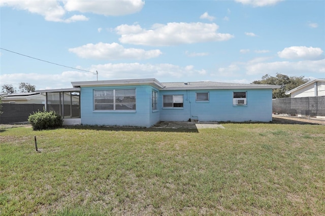 back of house featuring a sunroom, fence, and a yard