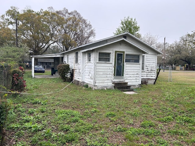 exterior space featuring entry steps and a front yard