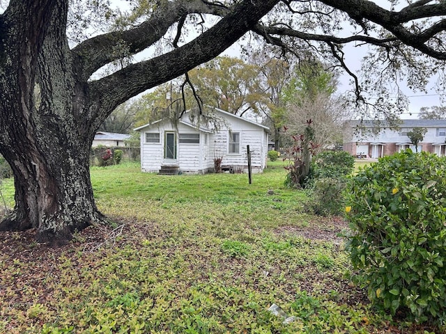 view of yard featuring entry steps and fence