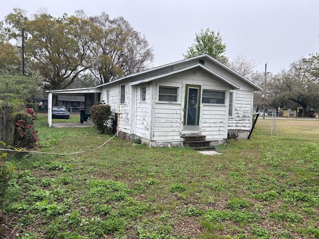 exterior space featuring entry steps and a lawn