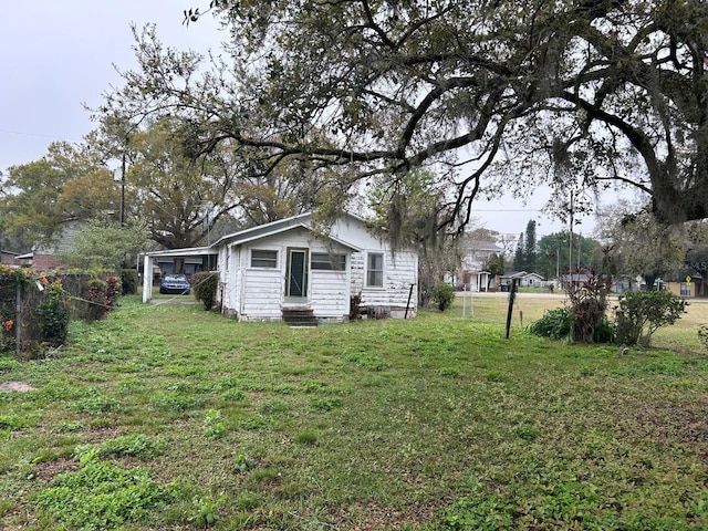 view of yard featuring entry steps and fence