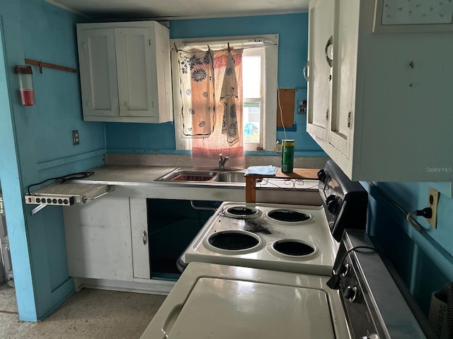 kitchen with white cabinets, white range with electric cooktop, light countertops, and a sink