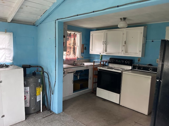 kitchen featuring range with electric stovetop, a sink, white cabinetry, freestanding refrigerator, and washer / dryer