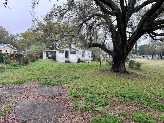 view of yard featuring entry steps and fence