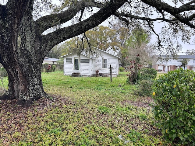 view of yard featuring entry steps and fence