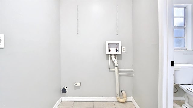 clothes washing area featuring a wealth of natural light, laundry area, tile patterned floors, and washer hookup