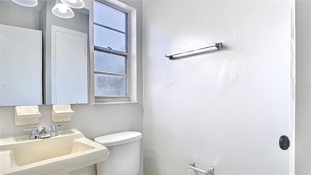 bathroom with toilet and a sink