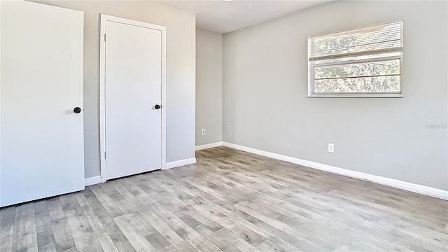 unfurnished bedroom featuring baseboards and light wood finished floors