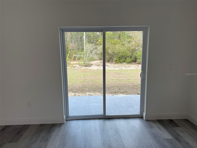 doorway to outside with plenty of natural light, baseboards, and wood finished floors