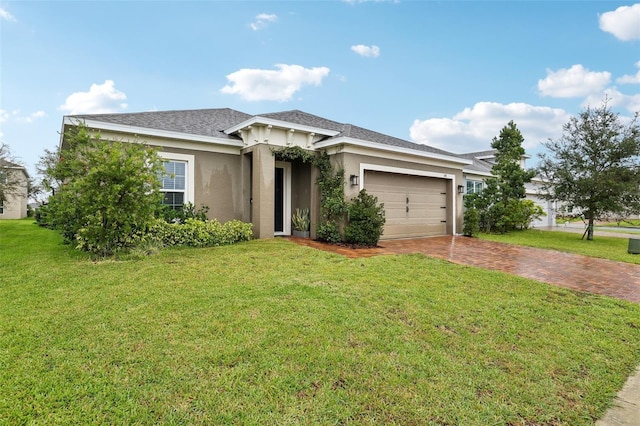 ranch-style home featuring a garage, roof with shingles, decorative driveway, stucco siding, and a front yard